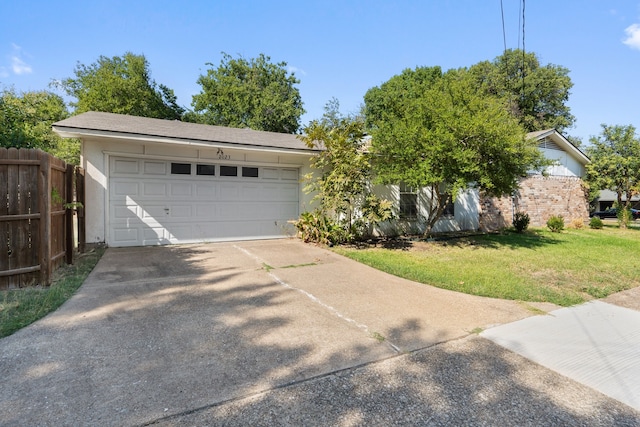 view of front of property featuring a front lawn and a garage