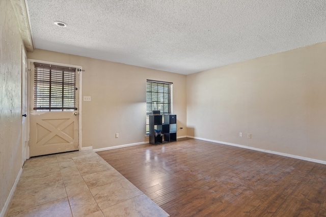 foyer entrance featuring light wood-type flooring and a textured ceiling