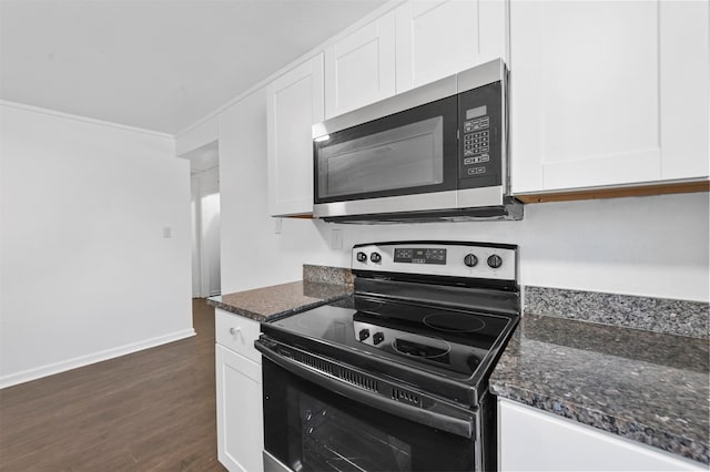 kitchen with white cabinetry, black / electric stove, crown molding, dark stone countertops, and dark wood-type flooring