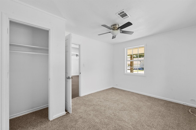 unfurnished bedroom featuring carpet floors, a closet, and ceiling fan