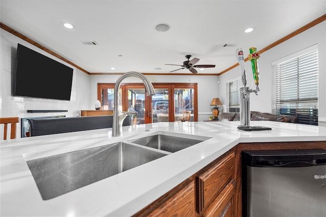 kitchen featuring crown molding, sink, and ceiling fan