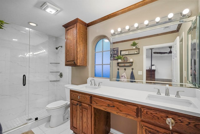 bathroom featuring vanity, tile patterned floors, toilet, ornamental molding, and an enclosed shower