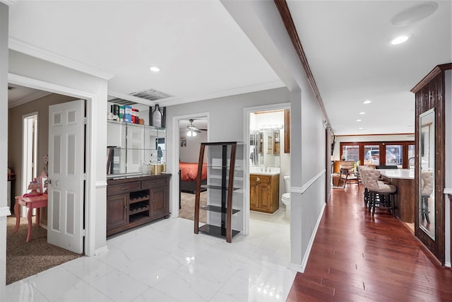 hallway featuring light hardwood / wood-style floors and ornamental molding