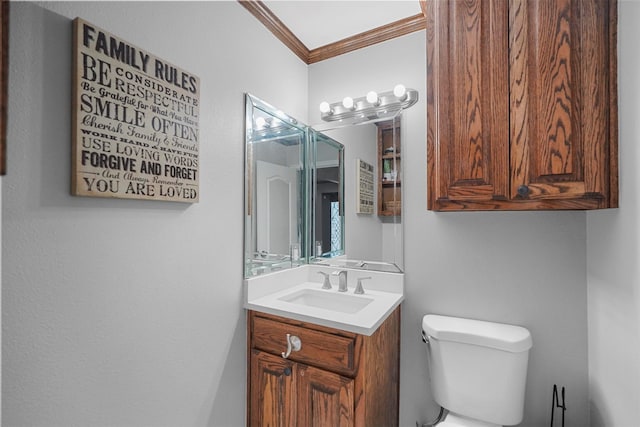 bathroom with vanity, toilet, and crown molding