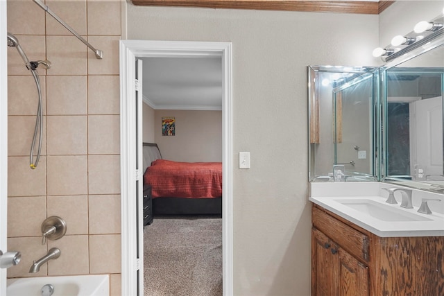 bathroom featuring vanity, ornamental molding, and tiled shower / bath combo