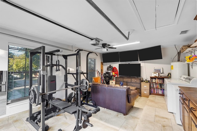 exercise area with water heater, ceiling fan, and independent washer and dryer