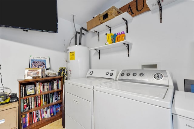 clothes washing area with washer and dryer, gas water heater, and light hardwood / wood-style floors