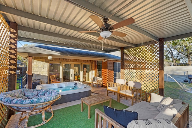 view of patio featuring outdoor lounge area, ceiling fan, and an outdoor hot tub