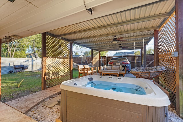 view of patio with ceiling fan and a hot tub