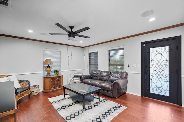 living room featuring hardwood / wood-style flooring, ceiling fan, and ornamental molding