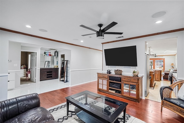 living room with light hardwood / wood-style floors and crown molding