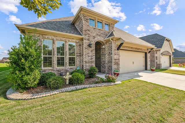 view of front of house with a front yard and a garage