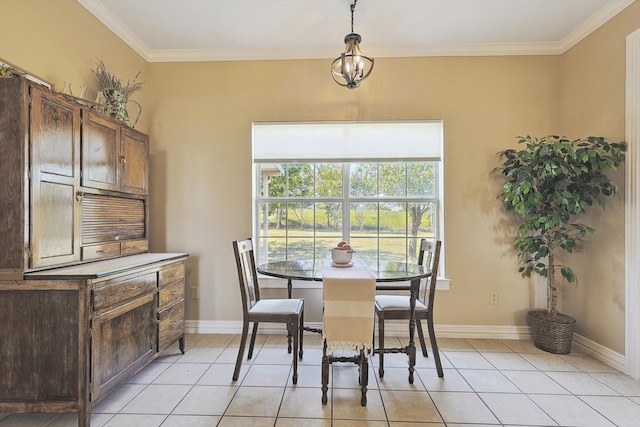 tiled dining room featuring crown molding and an inviting chandelier