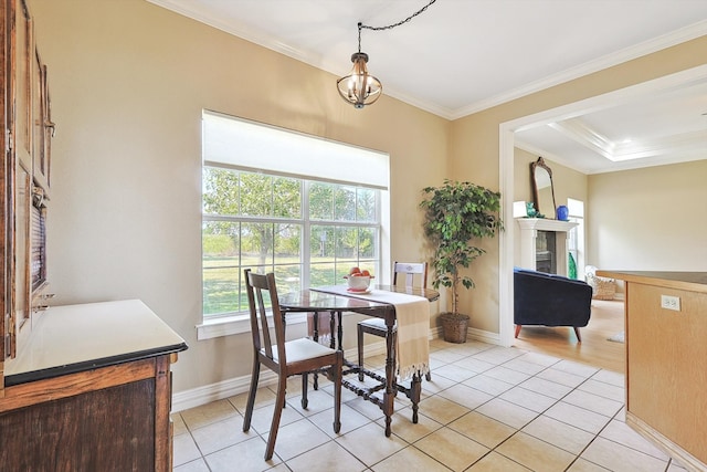 tiled dining space featuring crown molding and a chandelier