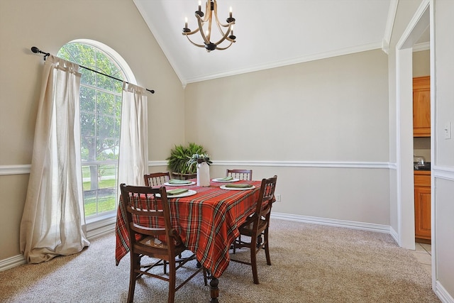 carpeted dining room with ornamental molding, vaulted ceiling, and a chandelier