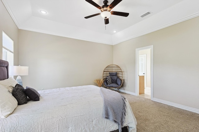 carpeted bedroom with crown molding, ceiling fan, and a raised ceiling