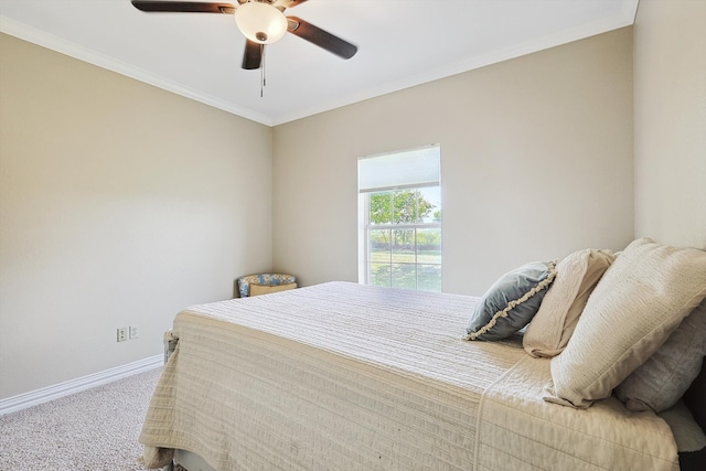 carpeted bedroom featuring ceiling fan and crown molding