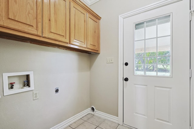 laundry area featuring electric dryer hookup, washer hookup, light tile patterned floors, and cabinets