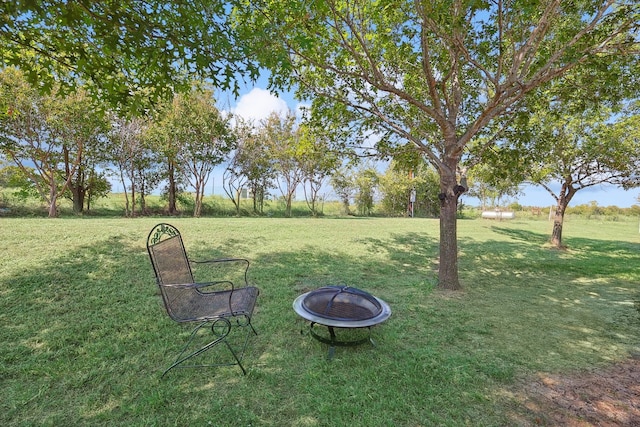 view of yard with an outdoor fire pit