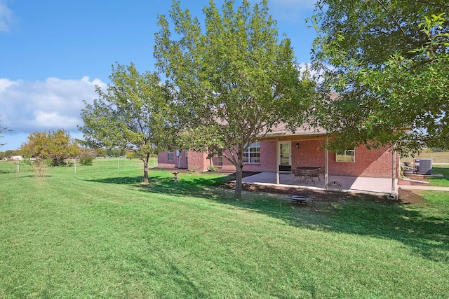 view of yard with a patio area and central air condition unit