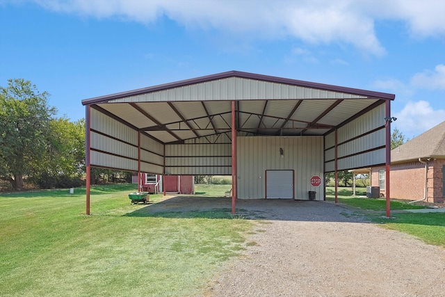 view of outdoor structure featuring a carport, central air condition unit, and a yard