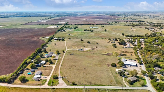 birds eye view of property with a rural view