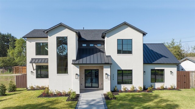 modern farmhouse style home with a front lawn