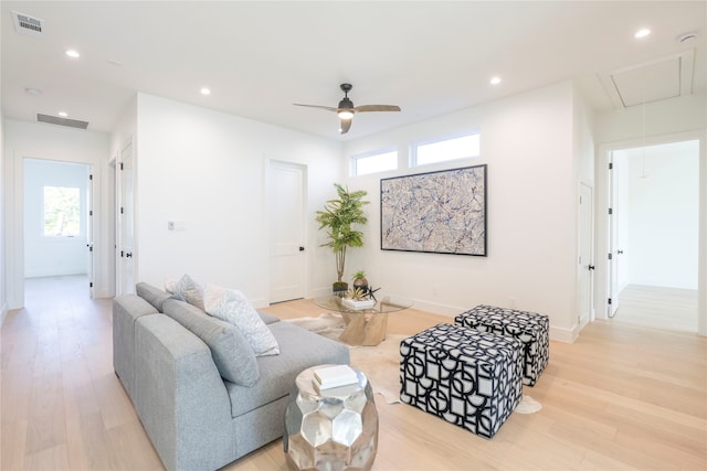 living room featuring ceiling fan and light hardwood / wood-style flooring