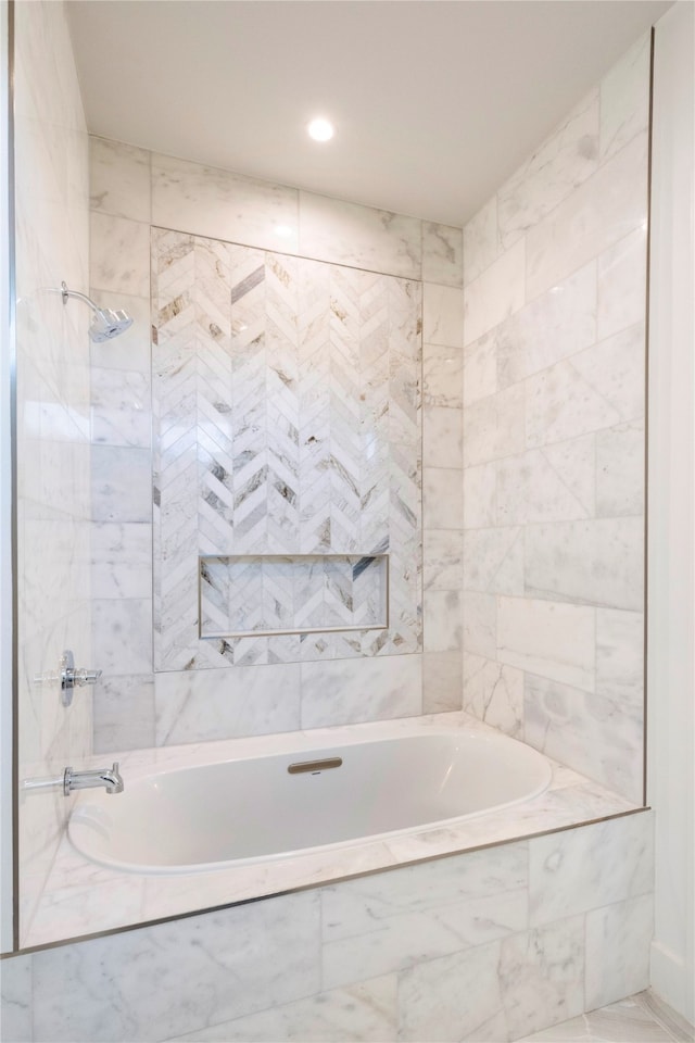 bathroom featuring tiled shower / bath