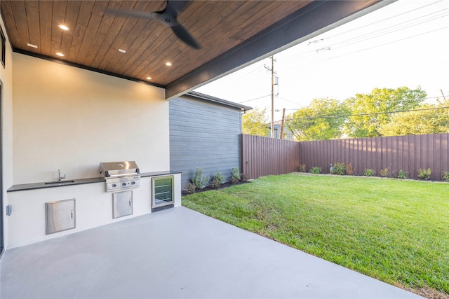 view of patio with wine cooler, a grill, sink, and an outdoor kitchen