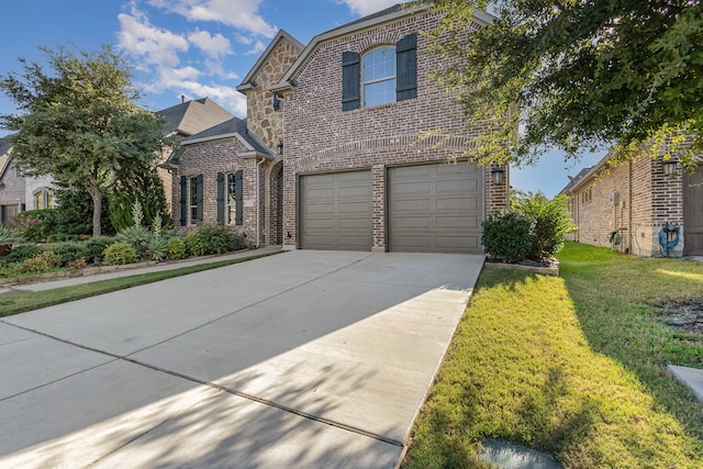 view of property featuring a front yard and a garage