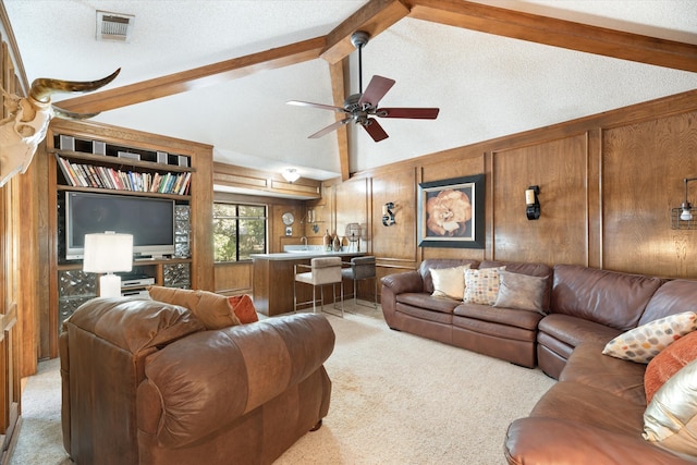 living room with light carpet, vaulted ceiling with beams, a textured ceiling, and wood walls