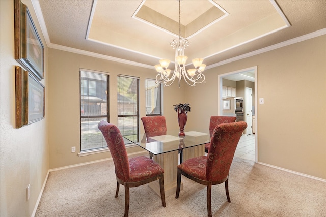 dining area with a raised ceiling, ornamental molding, light colored carpet, and a notable chandelier