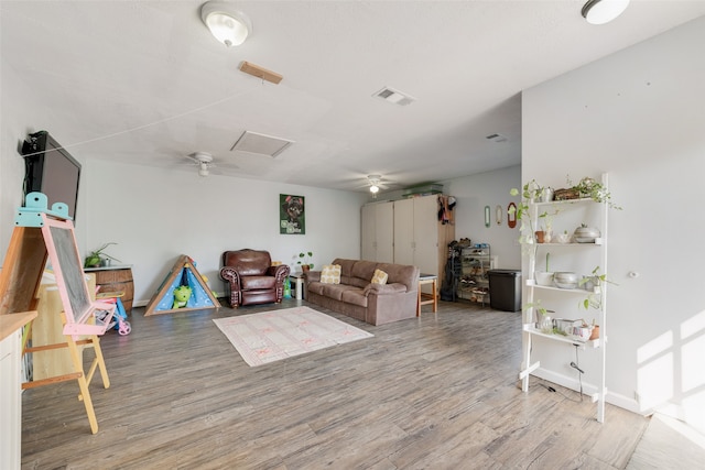 living room featuring hardwood / wood-style flooring and ceiling fan