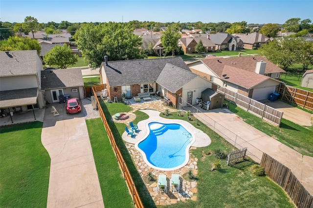 view of swimming pool with a patio area, an outdoor structure, and a yard