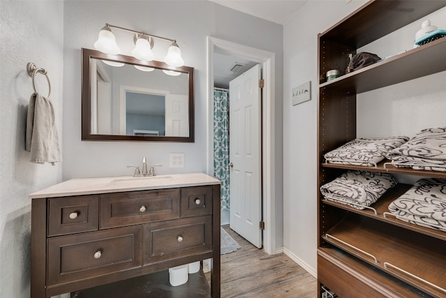 bathroom featuring hardwood / wood-style floors and vanity