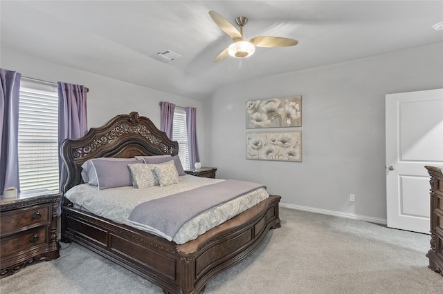 carpeted bedroom featuring multiple windows and ceiling fan