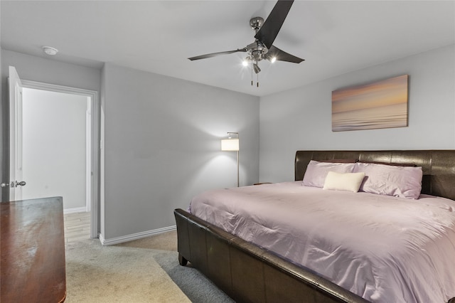 bedroom with ceiling fan and light carpet