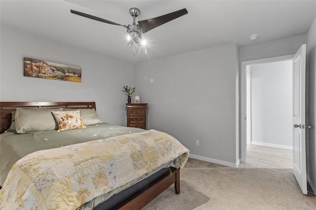 bedroom with ceiling fan and light carpet