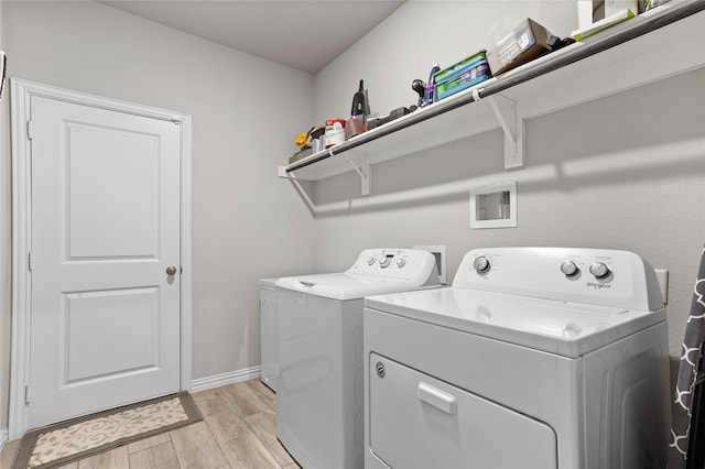 laundry room featuring light hardwood / wood-style floors and independent washer and dryer