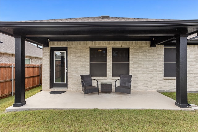 rear view of property with a yard and a patio