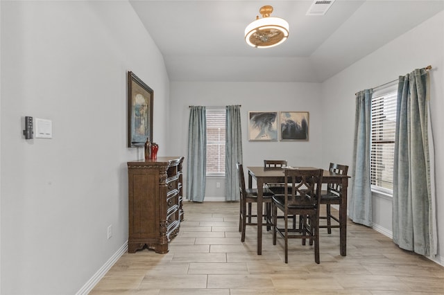 dining area featuring light hardwood / wood-style floors and lofted ceiling