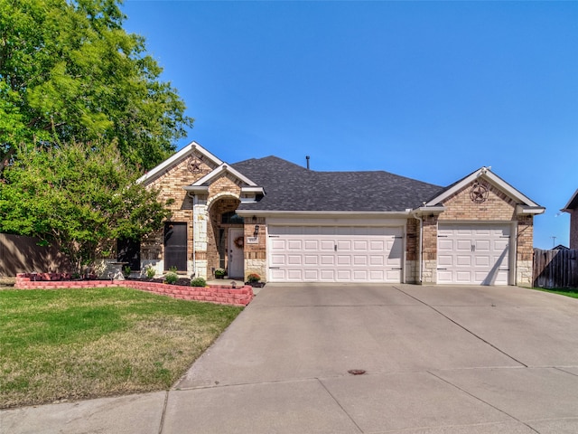 view of front of property with a garage and a front yard