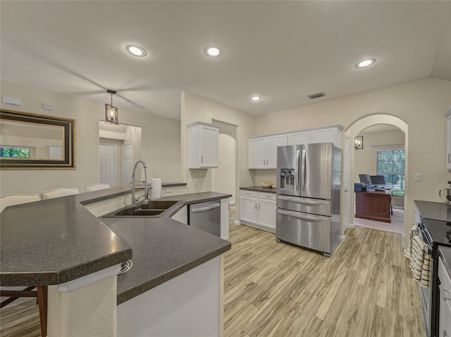 kitchen with white cabinetry, a kitchen island with sink, stainless steel appliances, and a breakfast bar