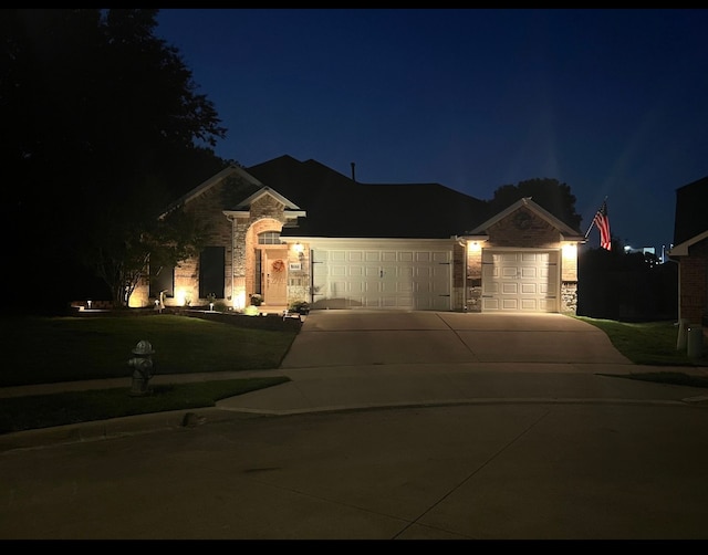 ranch-style house with a yard and a garage