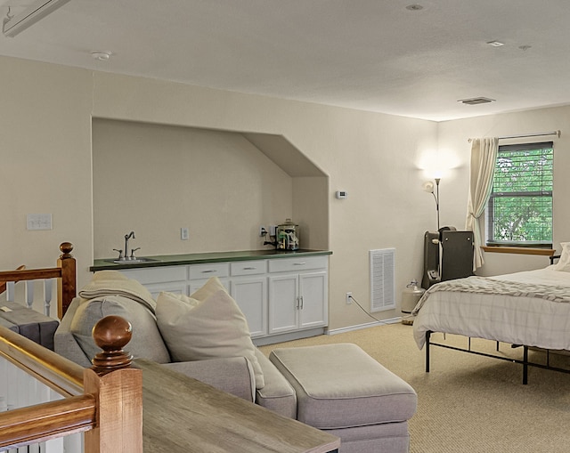 carpeted bedroom with sink