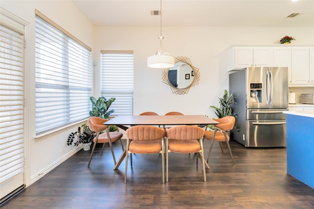 dining area with a healthy amount of sunlight and dark hardwood / wood-style floors