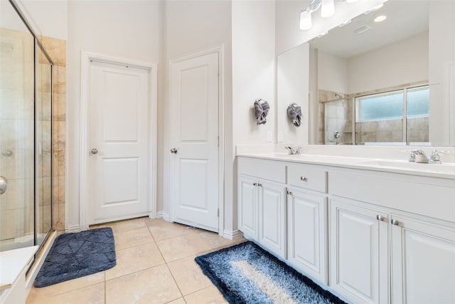 bathroom with tile patterned flooring, vanity, and a shower with shower door