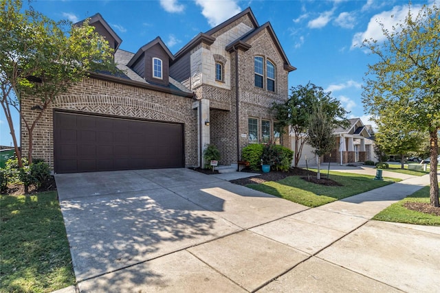 view of front of property featuring a garage and a front lawn