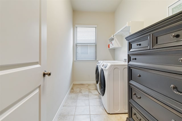 clothes washing area with light tile patterned floors and washing machine and clothes dryer